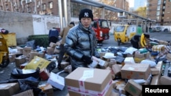 Delivery workers sort parcels at a makeshift logistics station near the Central Business District during Singles’ Day shopping festival in Beijing, China November 11, 2021.