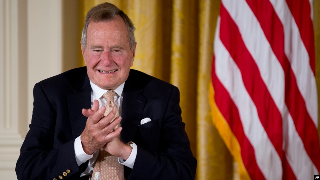 Former President George H. W. Bush applauds as he participated in a ceremony to present the 5,000th Daily Point of Light Award to Floyd Hammer and Kathy Hamilton, of Union, Iowa, in the East Room of the White House in Washington, July 15, 2013.