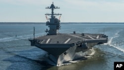 FILE - The USS Gerald R. Ford embarks on the first of its sea trials to test various state-of-the-art systems on its own power for the first time, from Newport News, Virginia, in an undated photo provided by the U.S. Navy.