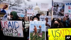 Demonstrators and lawmakers rally against President Donald Trump and his ally Elon Musk and their plans for the US Agency for International Development, which administers foreign aid approved by Congress, on Capitol Hill in Washington, Feb. 5, 2025.