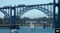 A charter fishing boat heads to sea from Newport, Oregon.