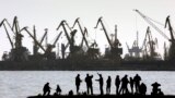People fish on a pier at the port of Mariupol, located on the north of the Sea of Azov in eastern Ukraine.