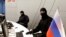 FILE - Members of Russia's FSB security service are seen during a raid in Moscow, Sept. 5, 2016.