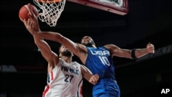 United States' Jayson Tatum (10) is fueled by France's Rudy Gobert (27) during a men's basketball preliminary round game at the 2020 Summer Olympics, July 25, 2021, in Saitama, Japan.