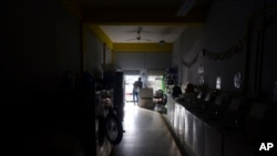 Laundromat owner Jesus Vazquez pauses before closing his San Juan, Puerto Rico, shop to comply with the government's coronavirus curfew on March 20.