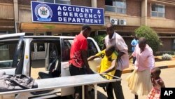 FILE: A family brings a sick relative to Parerenyatwa Hospital in Harare, Monday, Oct, 14, 2019. Zimbabwean doctors have been on strike for more than five months over low wages and bad working conditions which have plunged the country into a crisis. 