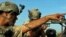 A US soldier, part of the NATO forces, patrols a police station after it was attacked by militants in Kandahar, south of Kabul, Afghanistan, June 19, 2012.