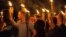 FILE - White supremacists carry torches on the grounds of the University of Virginia, on the eve of a planned "Unite the Right" rally in Charlottesville, Virginia, Aug. 11, 2017.