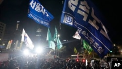 People gather to demand South Korean President Yoon Suk Yeol step down, in front of the National Assembly in Seoul, South Korea, Dec. 4, 2024.