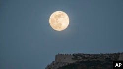 The moon rises above the castle of Acrocorinth, the acropolis of ancient Corinth, about 80 kilometers southwest of Athens on May 6, 2020.