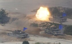 FILE - South Korean tanks fire during the South Korea-U.S. joint military drills in Pocheon, South Korea, near the border with North Korea, Aug. 28, 2015.