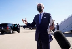 U.S. President Joe Biden talks to reporters as he arrives at New Castle Airport in New Castle, Delaware, March 26, 2021.