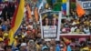 FILE - A supporter holds up a banner with images of opposition leader Maria Corina Machado and presidential candidate Edmundo Gonzalez during a campaign rally in Maracaibo, Venezuela, on May 2, 2024.