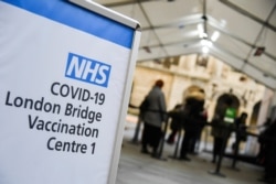 People wait to receive a COVID-19 vaccine at the London Bridge vaccination center, amidst the spread of the coronavirus disease (COVID-19), in London, Dec. 30, 2020.