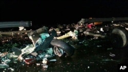 The wreckage of a U.S. military AH-64 Apache helicopter is strewn on a road in Wonju, South Korea, Nov. 23, 2015.