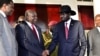 FILE - Leader of the Sudan People's Liberation Movement in Opposition (SPLM-IO) Riek Machar shakes hands with South Sudan's President Salva Kiir after a tripartite summit at the State House in Entebbe, Uganda, Nov. 7, 2019.