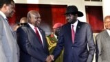 Leader of the Sudan People's Liberation Movement in Opposition (SPLM-IO) Riek Machar shakes hands with South Sudan's President Salva Kiir after a tripartite summit at the State House in Entebbe, Uganda, Nov. 7, 2019.