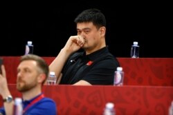 FILE - Yao Ming, head of the Chinese Basketball Association and former NBA player, watches as China and Venezeula compete during their group phase basketball game at the Cadillac Arena in Beijing, China, Sept. 4, 2019.