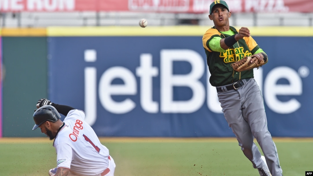Cuban National baseball team shortstop Dainer Moreira(R) forcing out Dominican National baseball team outfielder Leury Garcia (1) at second base as the teams play in the Serie Del Caribe, in San Juan, Puerto Rico, Feb. 3, 2015. 