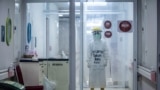 A medical staff wears personal protective equipment (PPE) with the words "Happy New Year 2021" to encourage COVID-19 coronavirus patients while working at the Bogor City Hospital in West Java.