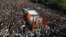 Supports of the Shiv Sena party crowd around the vehicle carrying the body of right-wing Hindu nationalist politician Bal Thackeray during his funeral procession in Mumbai, November 18, 2012. 