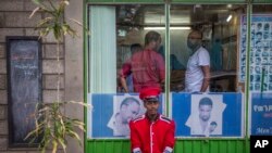 FILE - A security guard sits near a gate in Addis Ababa, Ethiopia.