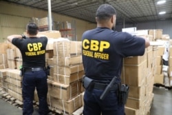 This handout photograph obtained July 1, 2020 courtesy of US Customs and Border Protection Office of Public Affairs and taken on June 29, 2020 shows Officers of Customs and Border Protection (CBP) Office of Field Operations (OFO) at the Port of New…