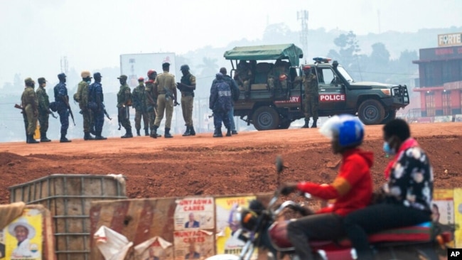 FILE - Security forces gather on election day in Kampala, Uganda, Jan. 14, 2021. Authorities in Uganda had recently suspended 54 aid groups, including Citizens' Coalition for Electoral Democracy and Chapter Four Uganda.