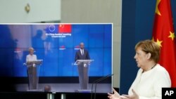 German Chancellor Angela Merkel, right, speaks as she holds a video news conference with European Council President Charles Michel, right on screen, and European Commission President Ursula von der Leyen, in Berlin, Sept. 14, 2020. 