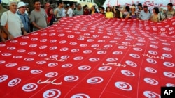 People demonstrate with a national's flags against Tunisia's Islamist-led government, in front of the Constituent Assembly headquarters in Tunis, Tunisia, Sept. 7, 2013. 