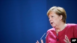 FILE - German Chancellor Angela Merkel gives a media statement in Berlin, Oct. 9, 2020.