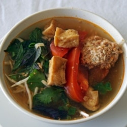 FILE - Linh Nguyen's Vietnamese soup features fried tofu, tomatoes, a scattering of fresh herbs and some delicate poached crab and pork dumplings.