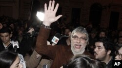 Paraguay's former President Fernando Lugo waves to followers gathered outside the Public Television building in downtown Asuncion, June 24, 2012. 