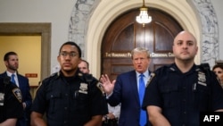Former U.S. President Donald Trump talks to members of the media outside the court room at the New York State Supreme Court on the first day of his civil fraud trial, in New York City on Oct. 2, 2023.