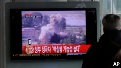 A South Korean man watches a TV news showing a file footage of North Korea's nuclear test at the Seoul train station in Seoul, South Korea, Tuesday, Feb. 12, 2013. The U.S. Geological Survey on Tuesday detected a magnitude 4.9 earthquake in North Korea. Neither Pyongyang nor Seoul confirmed whether North Korea had conducted its widely anticipated third nuclear test, though an analyst in Seoul said a nuclear detonation was a “high possibility.” (AP Photo/Lee Jin-man)