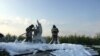 Firefighters spray foam on a wing of the Ural Airlines Airbus 321 passenger plane following an emergency landing in a field near Zhukovsky International Airport in Moscow Region, Russia, Aug. 15, 2019.