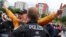 A police officer detains a protester who took off his mask during a protest against the government's restrictions following the coronavirus disease outbreak, in front of the headquarters of the European Central Bank, in Frankfurt, Germany, May 23, 2020.