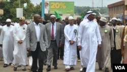 President Peter Mutharika, wearing a suit and tie, joins in a march marking Ziyala in Lilongwe, Malawi, Jan. 4, 2015. (Yusufu Chibwana/VOA)