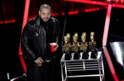 Post Malone appears on stage with his nine awards to include top male artist and top artist at the Billboard Music Awards on Oct. 14, 2020, at the Dolby Theatre in Los Angeles.