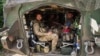 Ukrainian soldiers sit inside their armored personnel carrier after returning from Russia's Kursk region, near the border in the Sumy region of Ukraine on Aug. 14, 2024.