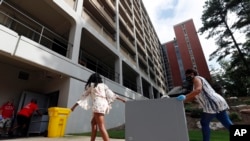 FILE - College students begin moving in for the fall semester at N.C. State University in Raleigh, N.C., Friday, July 31, 2020.