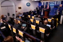 Reporters as questions of President Donald Trump as he speaks about the coronavirus in the James Brady Press Briefing Room of the White House, Friday, April 17, 2020, in Washington.