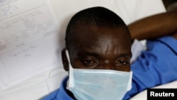 A mock coronavirus patient waits to be transported during an exercise simulating the treatment of a large number of coronavirus patients at the Aga Khan University Hospital in Nairobi, Kenya, April 9, 2020. 