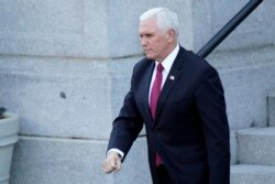 Vice President Mike Pence walks to the West Wing of the White House after addressing staff on the steps of the Eisenhower Executive Office Building, in the White House complex, January 19, 2021, in Washington.