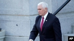 Vice President Mike Pence walks to the West Wing of the White House after addressing staff on the steps of the Eisenhower Executive Office Building, in the White House complex, Jan. 19, 2021.