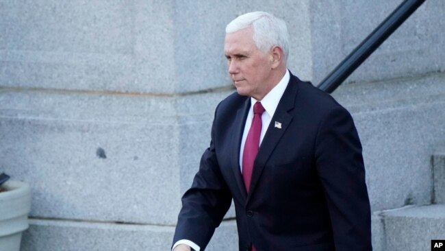 Vice President Mike Pence walks to the West Wing of the White House after addressing staff on the steps of the Eisenhower Executive Office Building, Jan. 19, 2021, in Washington.