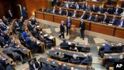 A Lebanese lawmaker, center, casts his vote to elect a new president, at the parliament building in downtown Beirut, Jan. 9, 2025. 