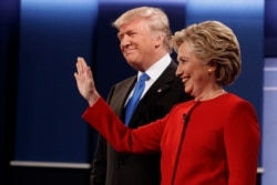 FILE - Republican presidential candidate Donald Trump, left, stands with Democratic presidential candidate Hillary Clinton before the first presidential debate, at Hofstra University in Hempstead, New York, September 26, 2016.