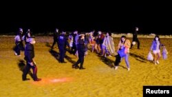 Police officers evict groups of more than six people at Barceloneta beach as the state of emergency to prevent the spread of the COVID-19 was lifted a week ago in Barcelona, Spain, May 16, 2021.