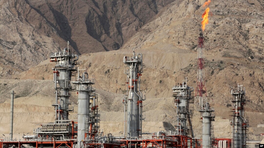 FILE - A gas flare burns in a gas refinery in South Pars gas field, on the northern coast of the Persian Gulf, in Asalouyeh, Iran, Jan. 22, 2014.